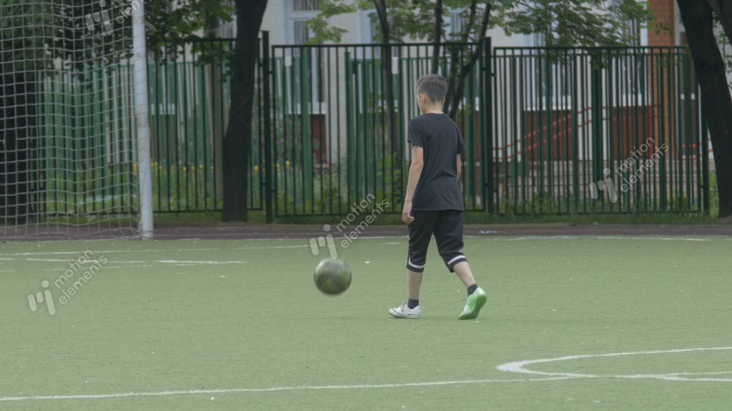 Boy Play Football Alone Stock video footage 9237344