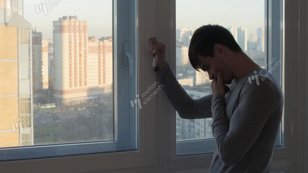 Worried Man Stand And Crying Near Window Stock video footage 8944978