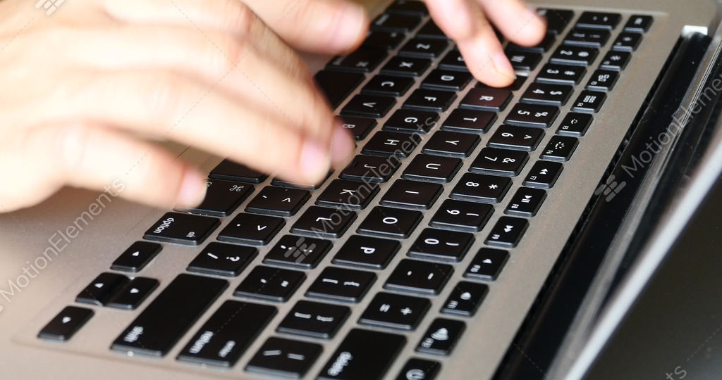 4k typing on a laptop keyboard, computer literate operator stock